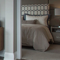 Medium unit interiors with bed nightstand and lamp at soleil condos 10 v21