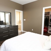Medium 19 emerald hill dr. show home for sale by emerald park homes white city walk out bungalow master bedroom with walk in closet and ensuite 1024x683