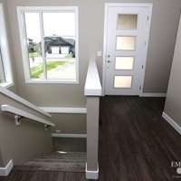Medium 19 emerald hill dr. show home for sale by emerald park homes white city walk out bungalow stair case with lots of natural light large windows over sized front door 1024x683